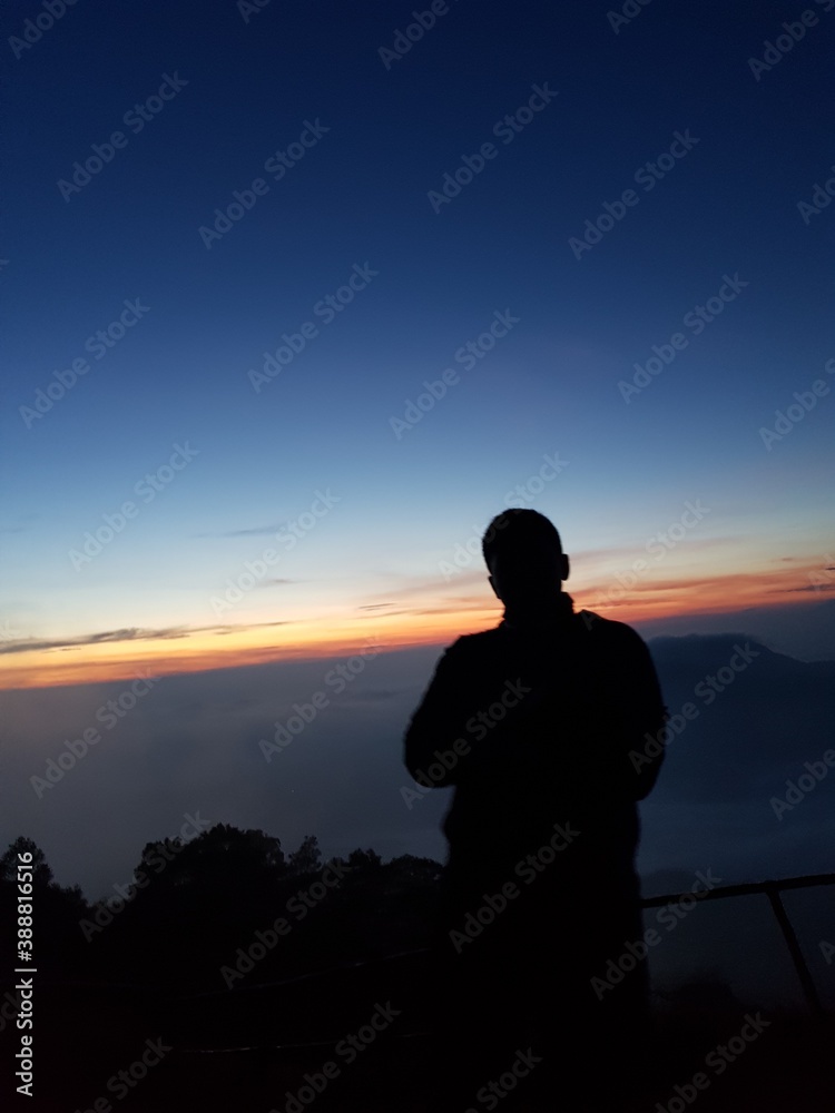 silhouette person at mountain sunrise 