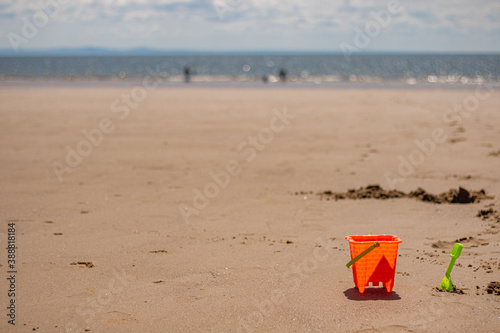 Fototapeta Naklejka Na Ścianę i Meble -  Orange bucket on a sandy beach