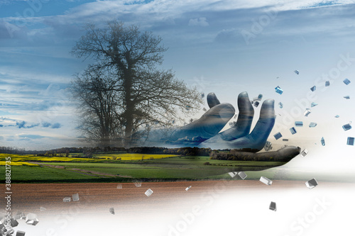 Digital hand over rural landscape