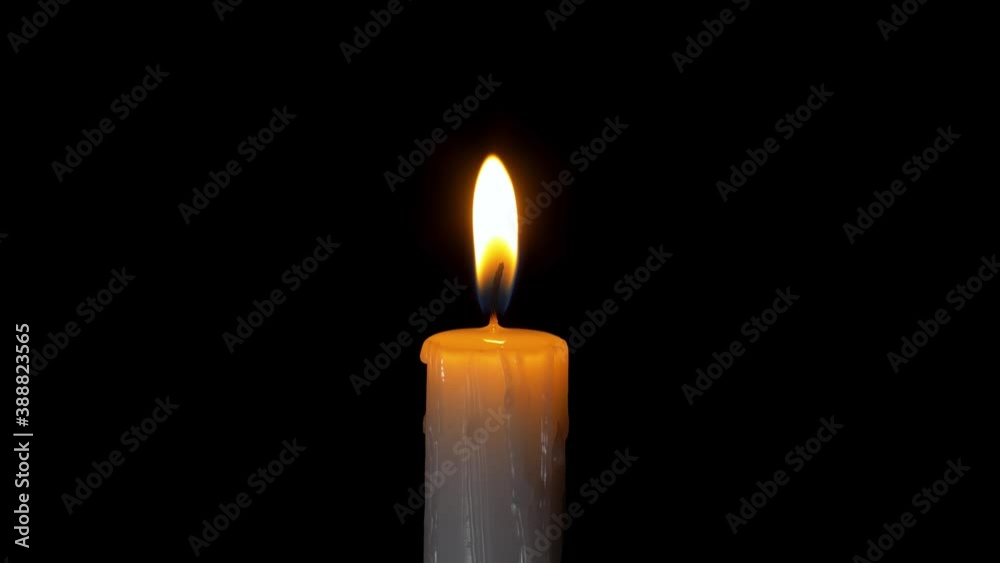 A single white candle burning.Isolated candle burning with dark background.White paraffin candle with yellow shades burns on a black background.Background or illustration of remembrance or celebration A single white candle burning.Isolated candle burning with dark background.White paraffin candle with yellow shades burns on a black background.Background or illustration of remembrance or celebration