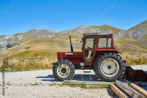 Image of a tractor in a mountain rural area.
