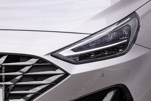 Front light of a new silver car © yakub88