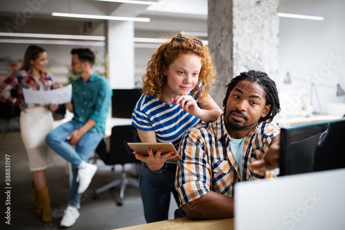 Programmers cooperating at IT company developing apps
