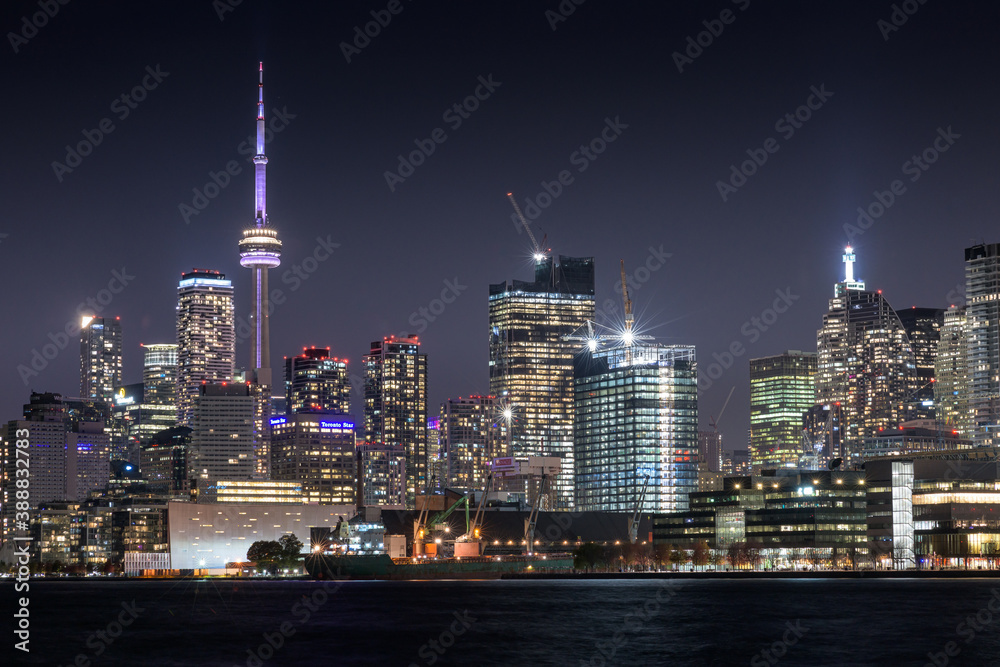 Toronto skyline at night featuring the CN tower and waterfront. Toronto skyline at night featuring the CN tower and waterfront.