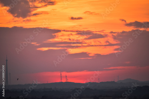 Landscape view of sunset over the city. Cloudy sky with dramatic sunset