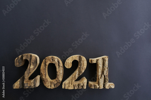 On a black background wooden numbers 2021, place for text. 
