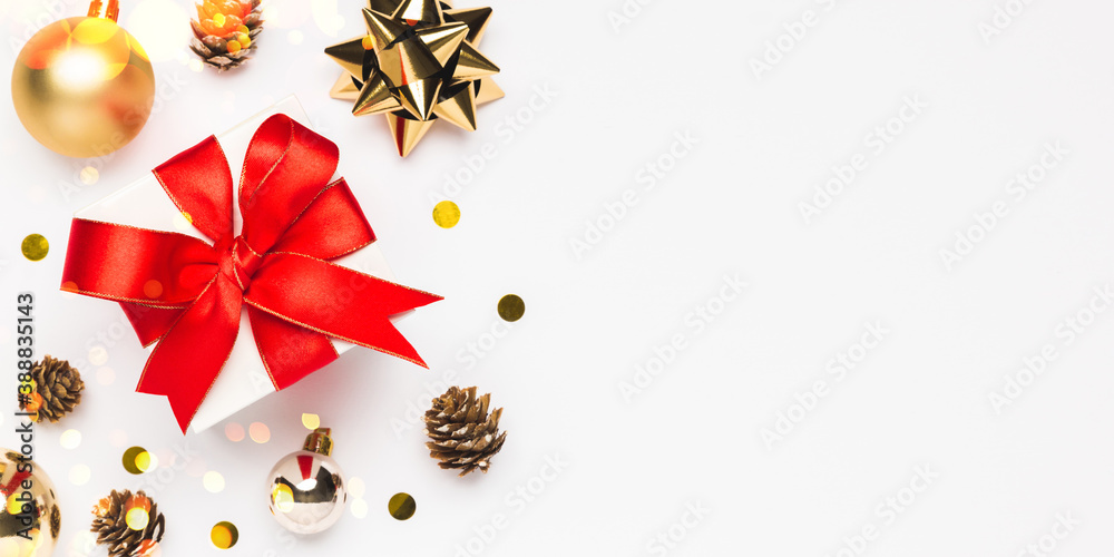 Merry Christmas and Happy Holidays greeting card background with copyspace on the right. Christmas gift and decor on white background top view. Winter xmas holiday theme in flat lay Merry Christmas and Happy Holidays greeting card background with copyspace on the right. Christmas gift and decor on white background top view. Winter xmas holiday theme in flat lay