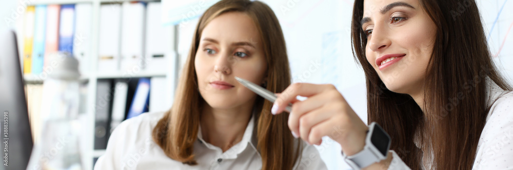 Portrait of smart businesswoman sitting at comfortable workplace and holding metallic writing pen with concentration and satisfaction. Accounting office concept Portrait of smart businesswoman sitting at comfortable workplace and holding metallic writing pen with concentration and satisfaction. Accounting office concept