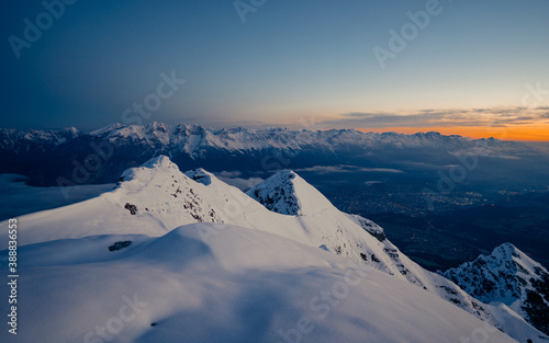 Sunrise on top of Nockspitze mountain in Austria. Innsbruck and the Alps are seen from the Mount. Winter alpine like mountain landscape in Austria.   photo