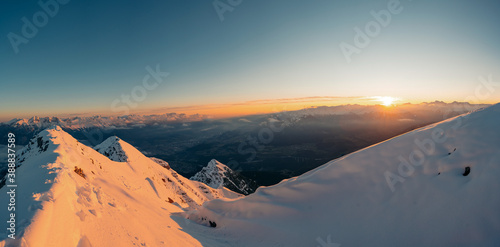 Winter panoramic view of gorgeous pink sunrise over glacier and high mountain peaks in the Alps. Mountain Nockspitze. Innsbruck and the Alps are seen from the Mount. Banne photo