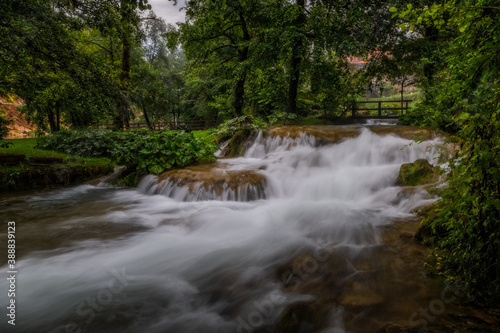 A flowing water of the mountain river in picturesque Rastoke village in Croatia. August 2020, long exposure picture.