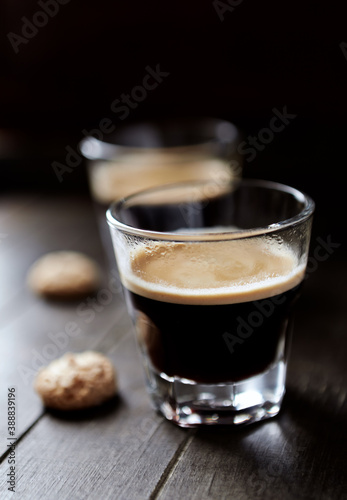 Two Glasses Of Coffee on dark wooden background. Close up. 