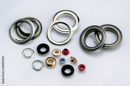Eyelets for the manufacture of banners, awnings, tents, clothes, bags, shoes. A set of multi-colored eyelets in different colors and sizes. metal elements for installation on garments.