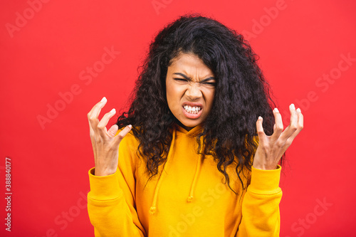 Nervous african woman breathing calming down relieving headache or managing stress, black girl feeling stressed isolated on red background.