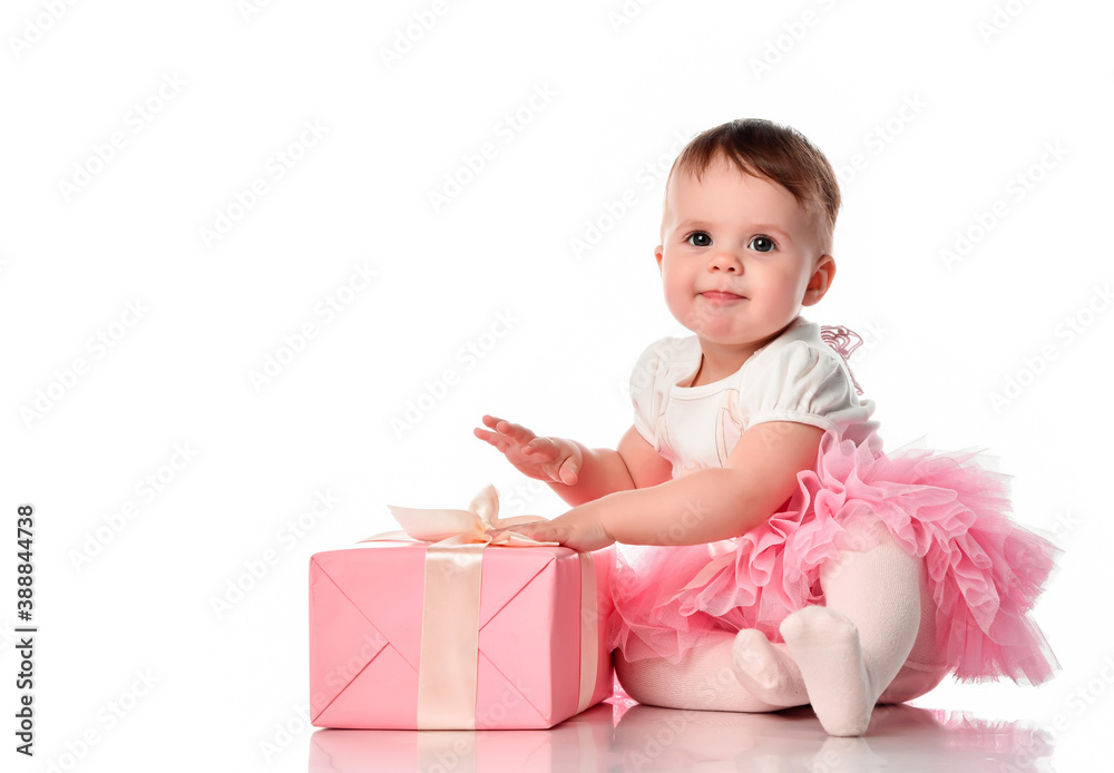 Girl sitting on the floor with a gift box and smiling. Girl sitting on the floor with a gift box and smiling.