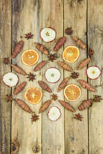 Weihnachtsdekoration Apfelscheiben, Orangenscheiben, Zimt und Anis auf rustikalem hözernen Hintergrund