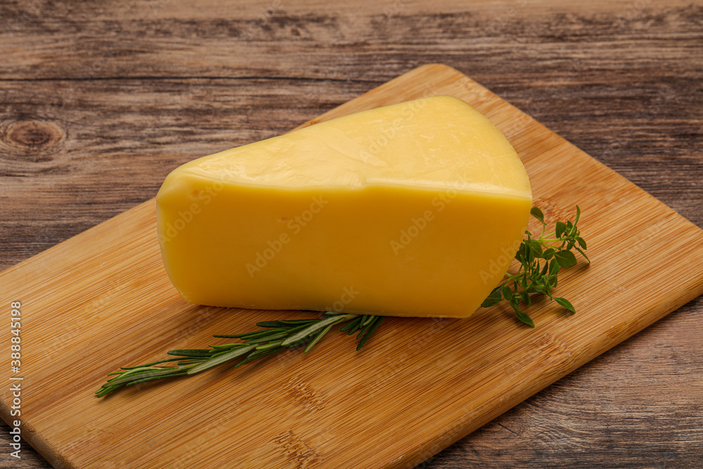Hard cheese piece served rosemary Hard cheese piece served rosemary