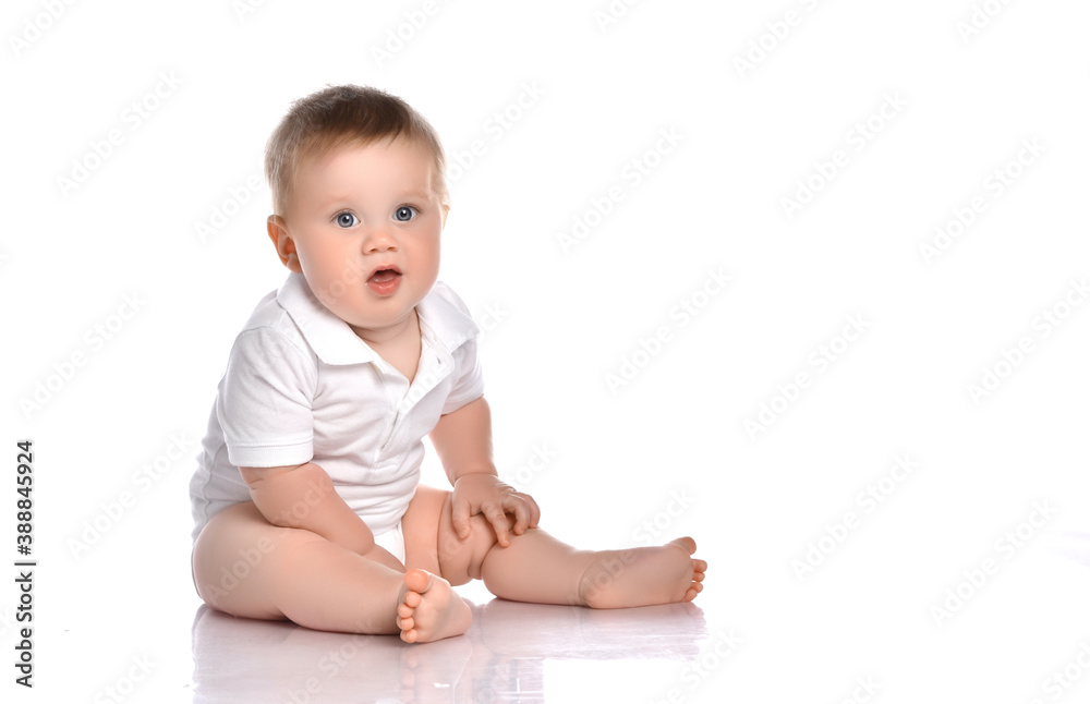 Cute little boy in white bodysuit sitting isolated on white Cute little boy in white bodysuit sitting isolated on white
