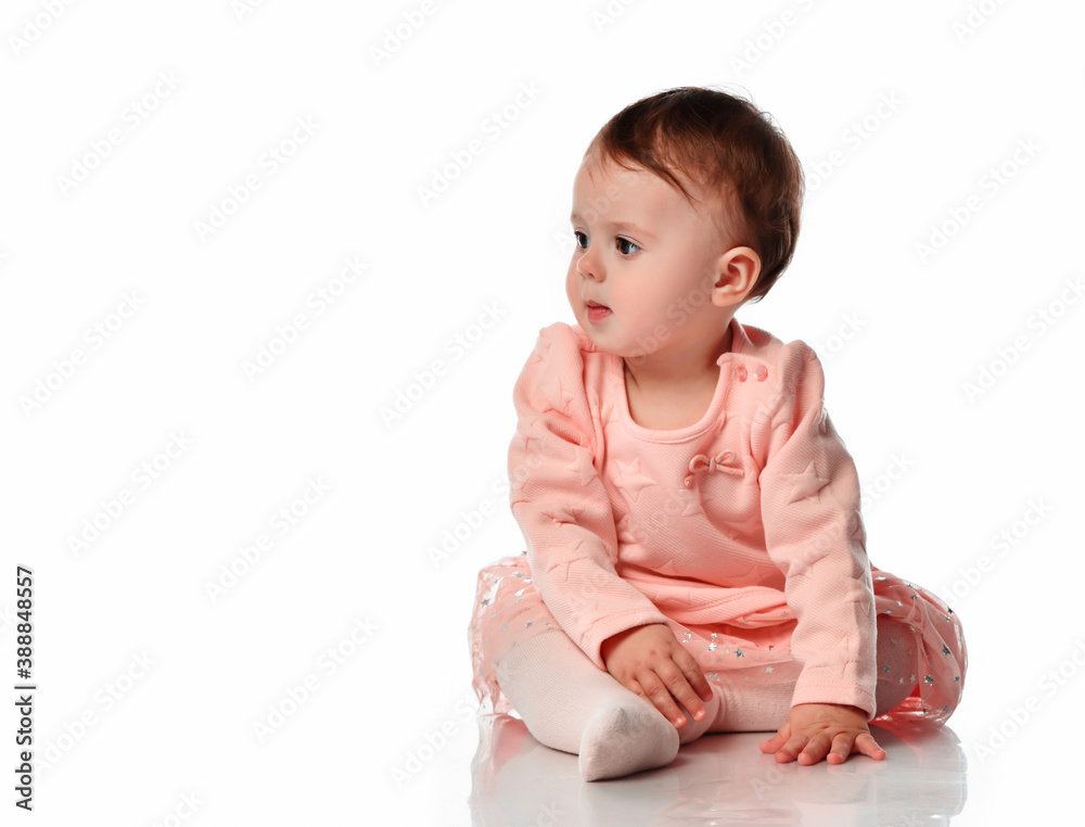 Cute baby girl sitting isolated on white background