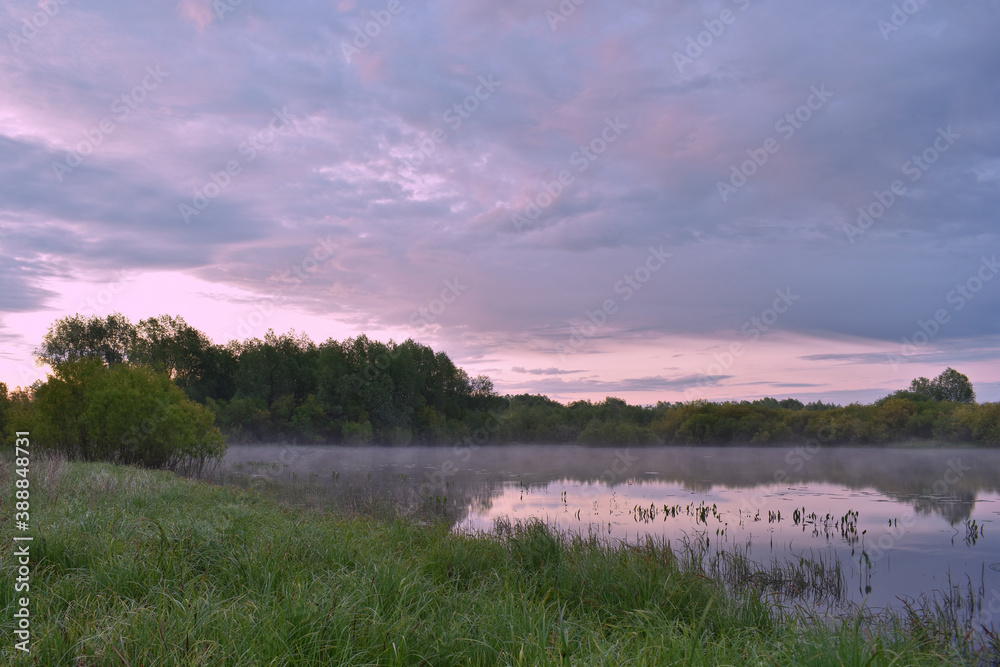 Obraz premium colorful and misty dawn over a small river