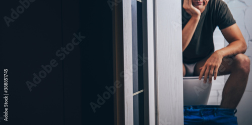 Quadro em tela Man sitting in toilet. Wc. Male.