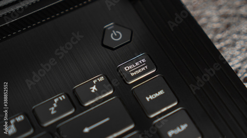 Close up the Delete key on the laptop keyboard. Insert key on keyboard. Modern black keyboard