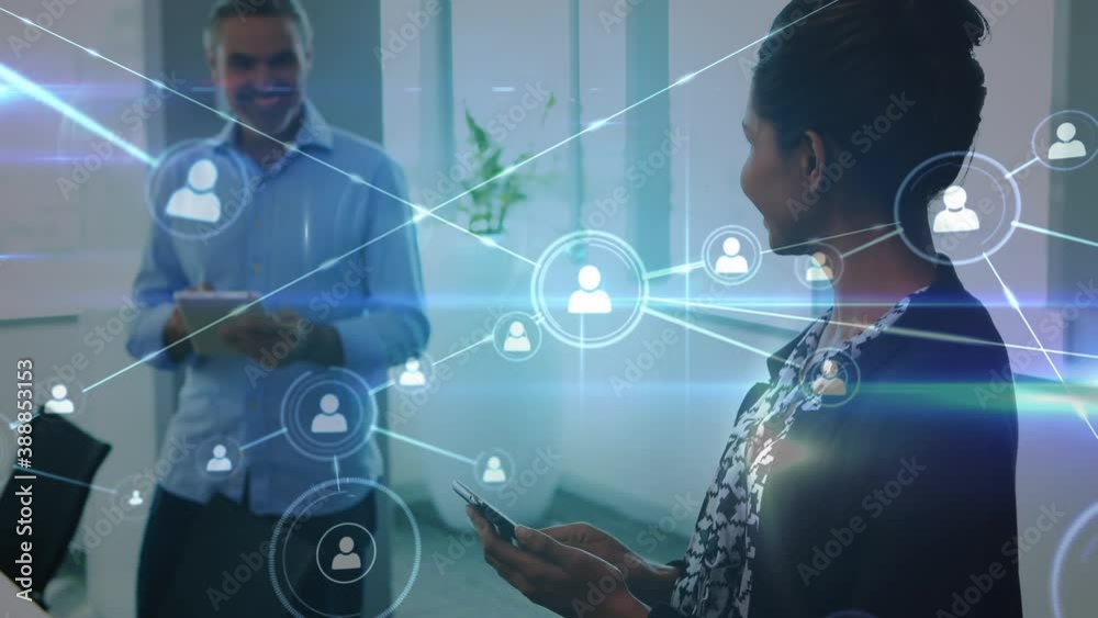 Network of connections with icons over colleagues using electronic devices