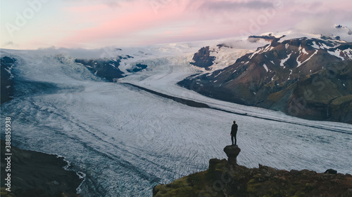 An adventure solo traveler at Svinafellsjokull glacier in the Vatnajokull National Park in Iceland. Beautiful landscape of Iceland.