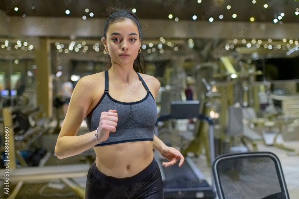 Fototapeta premium Woman Running on Treadmill