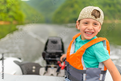 Little Boy Driving the Motorboat