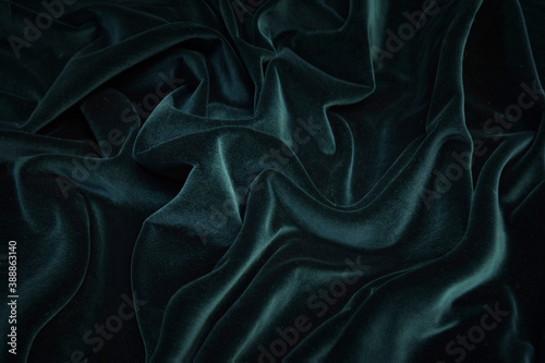 Texture, background, pattern. Texture of green velvet fabric. Beautiful emerald green soft velvet fabric. photo