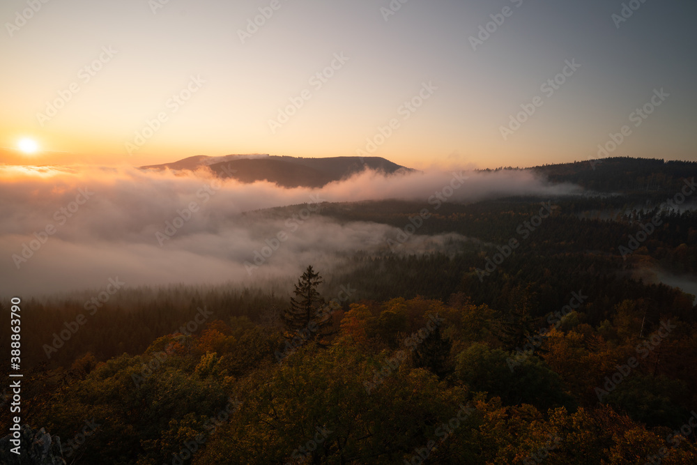 sunset in the mountains with low clouds
