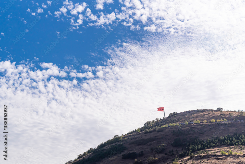 Turkish flag over the hill. with beautiful white clouds and blue sky