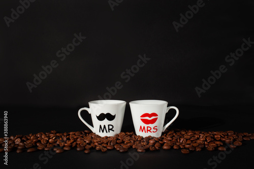 Espresso coffee cups with coffee beans on black background. Romantic mood card, valentines day.