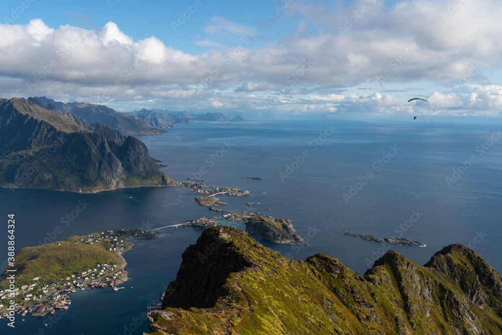 paraglider over the sea and mountain
