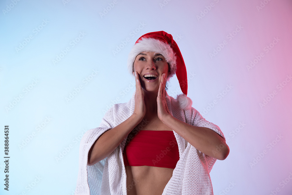 Obraz premium Portrait of beautiful female model wear santa hat. Christmas woman. Sensual. Emotion. Fun. Photo. 