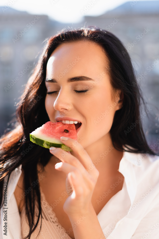portrait of brunette woman eating watermelon with closed eyes portrait of brunette woman eating watermelon with closed eyes