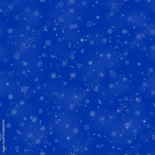 Christmas seamless pattern of snowflakes of different shapes, sizes and transparency, on blue background