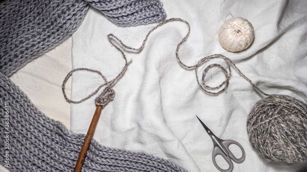 Photo of a crochet hook, wool yarn queens, knitting. Gray color scheme. Background for content. Crochet. Hobby. Flatley.