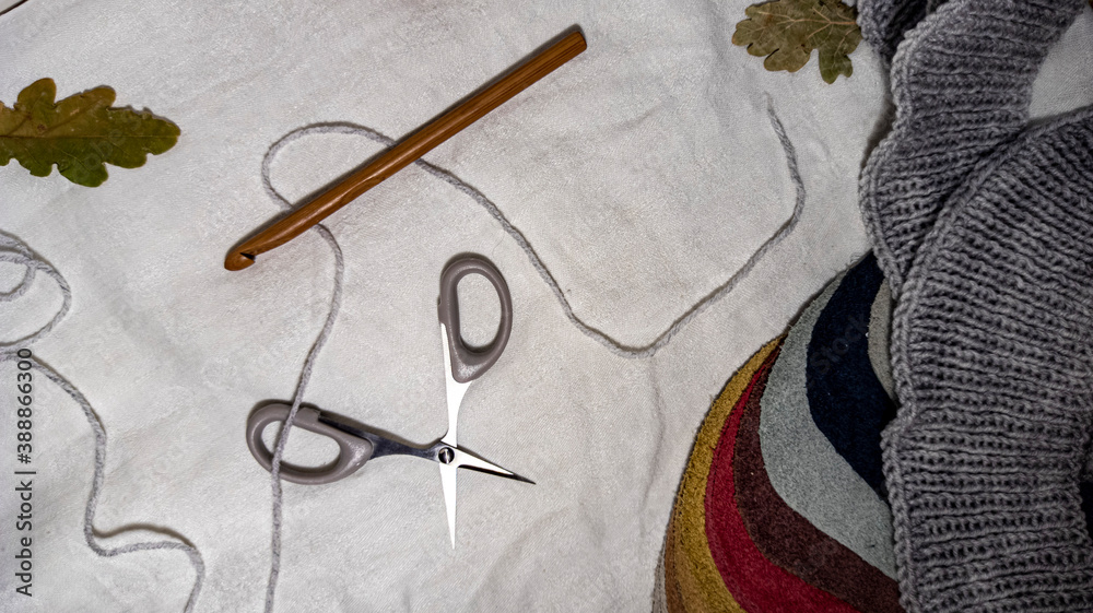 Photo of a crochet hook, wool yarn queens, knitting. Gray color scheme. Background for content. Crochet. Hobby. Flatley.