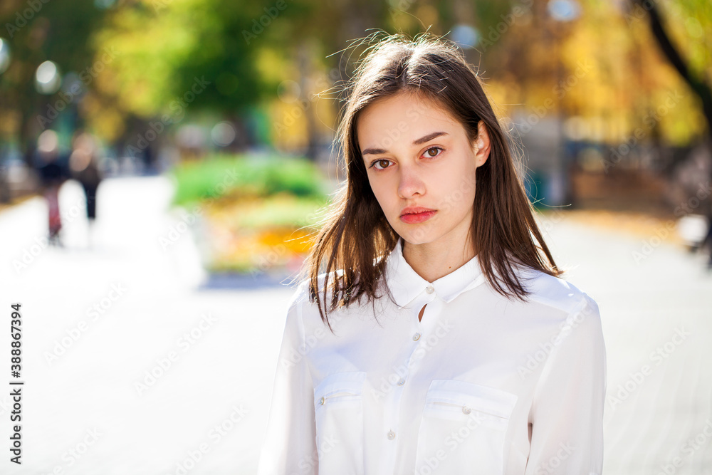 Close up portrait of a young brunette girl in white shirt Close up portrait of a young brunette girl in white shirt
