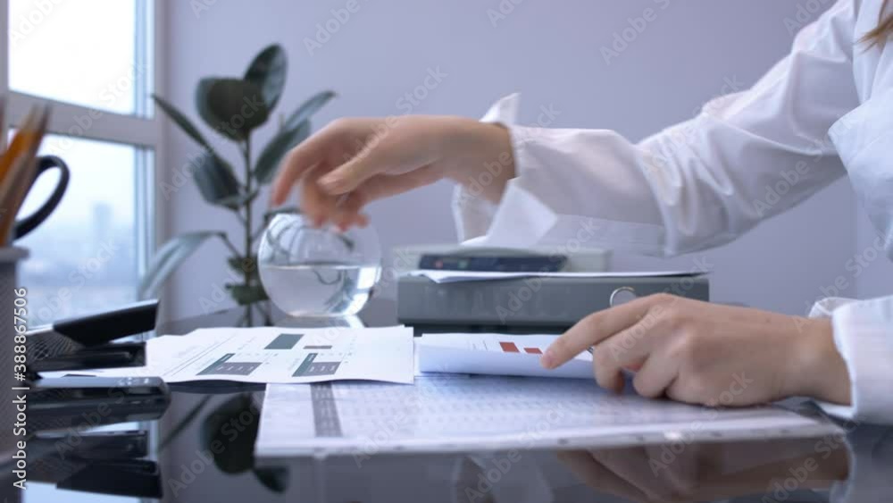Female hands take documents from the table and staple Female hands take documents from the table and staple