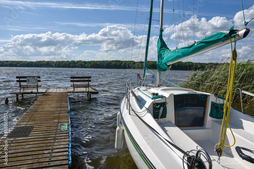 Sail boat anchored on the lake pier
