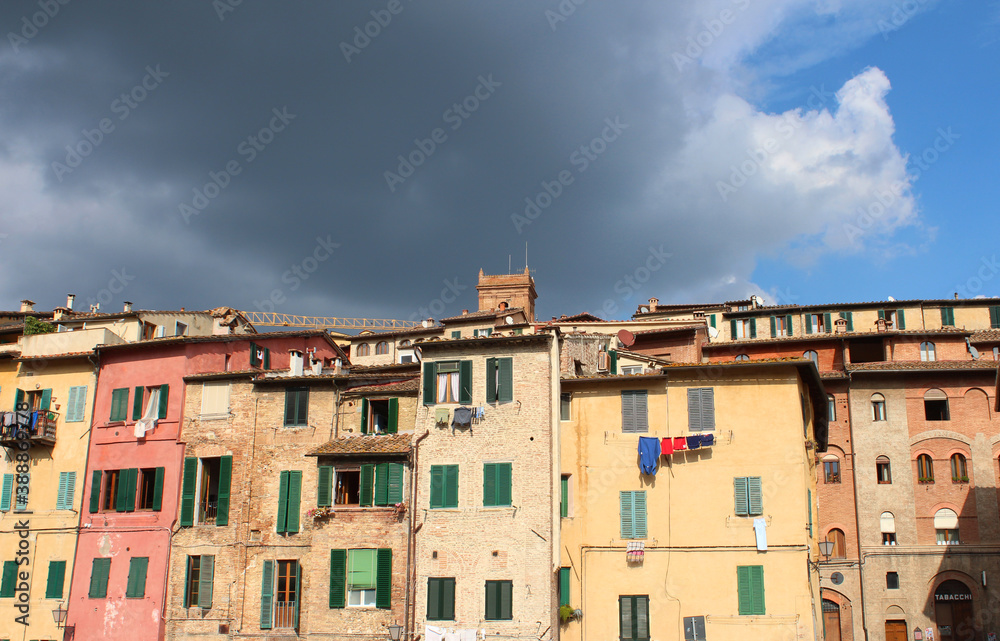 Facades of row houses in Sienna Italy