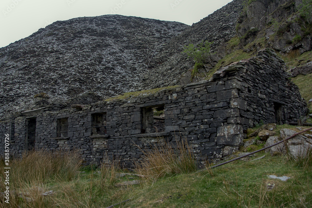 An abandoned British house in the mountains of slate and rock pieces