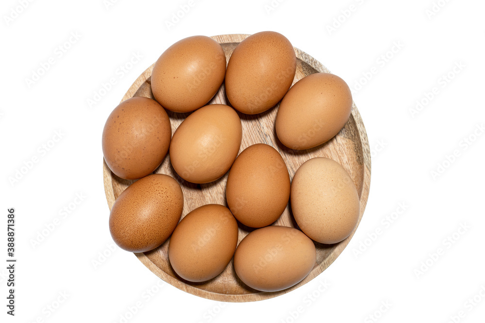 Brown raw chicken eggs on wooden plate isolated on white background. Brown raw chicken eggs on wooden plate isolated on white background.