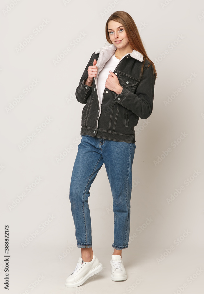 Young beautiful girl in a denim gray sweater on a white background .. Concept of beauty and fashion, Concept of jeans Young beautiful girl in a denim gray sweater on a white background .. Concept of beauty and fashion, Concept of jeans