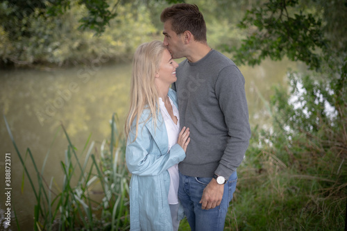 Young Couple Looking At Each Other Lovingly By A River