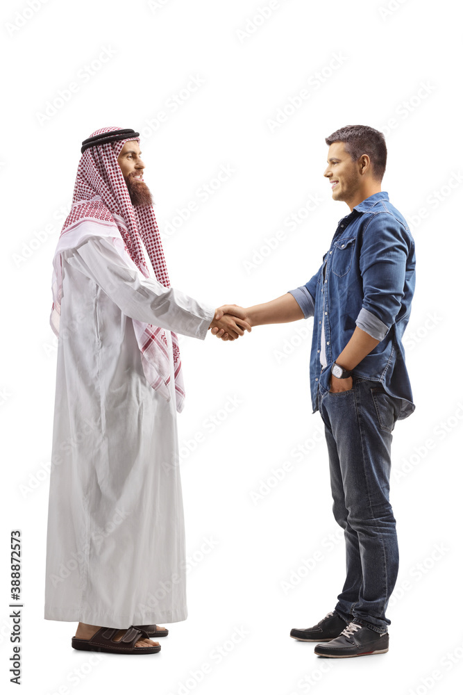 Full length profile shot of an arab man shaking hand with a casual young man Full length profile shot of an arab man shaking hand with a casual young man