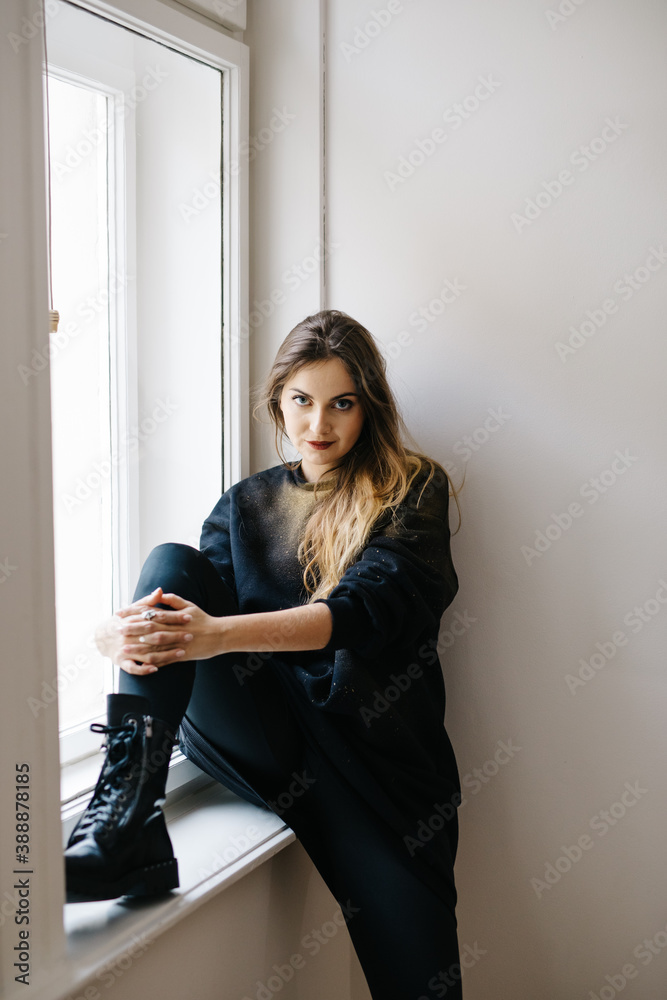 Dreamy lady near window